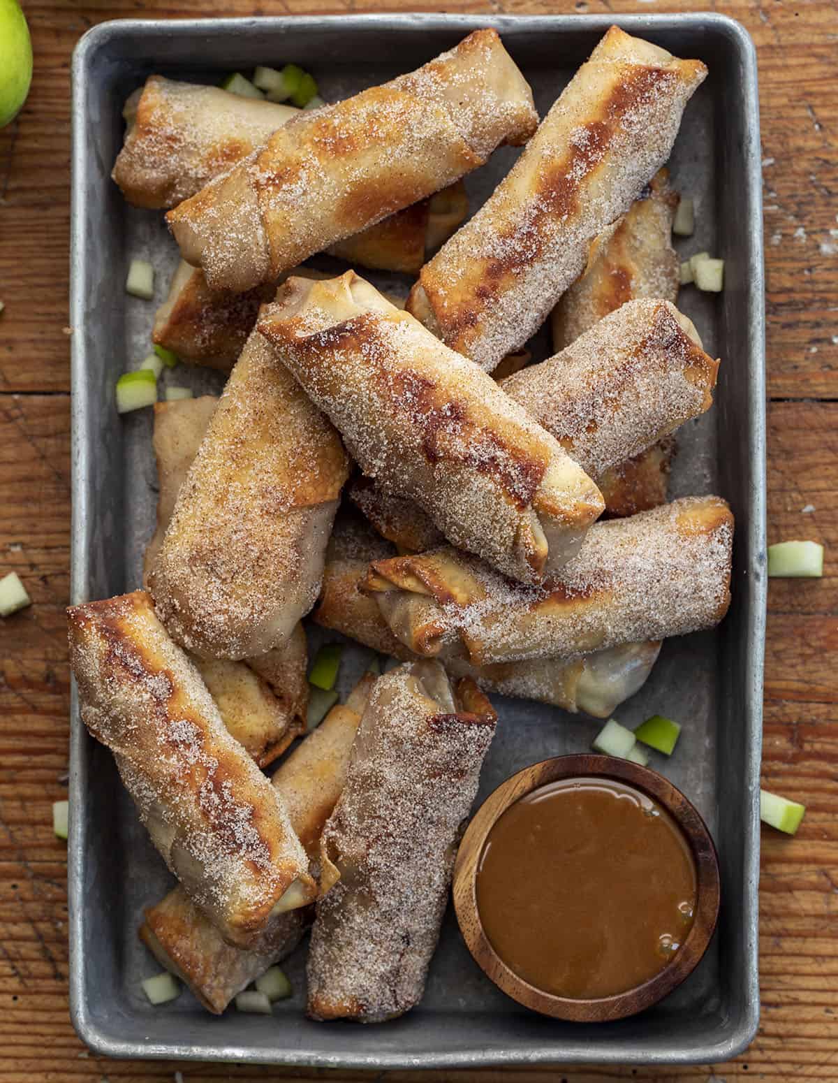 Apple Pie Egg Rolls in a Pan with Caramel Sauce and Green Apples. Dessert Egg Rolls, Apple Egg Rolls, Apple Pie Egg Rolls, Easy Apple Pie Recipes, Dessert, Air Fryer Apple Pie Egg Rolls, Oven Apple Pie Egg Rolls, Super Bowl Desserts, Thanksgiving Desserts, Christmas Desserts, Snacks, i am baker, iambaker