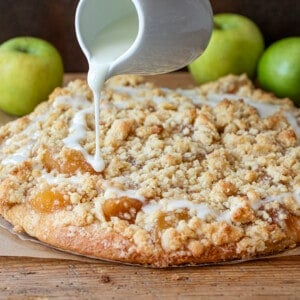 Pouring Glaze Over Apple Dessert Pizza.