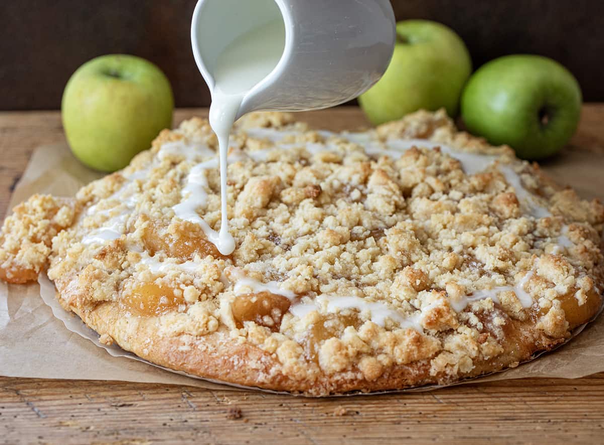 Pouring Glaze Over Apple Dessert Pizza.