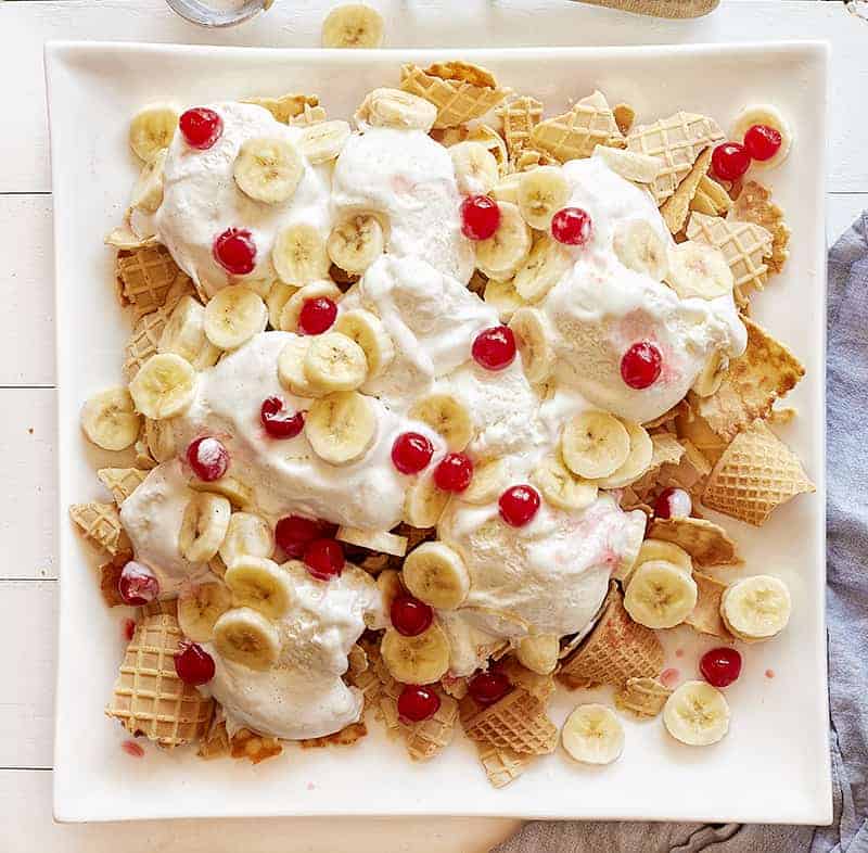 Topping Banana Split Waffles with bananas and cherries