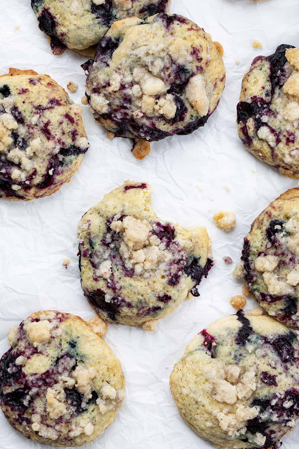 Blueberry Crumble Cake Cookies with Center Cookie Having a Bite Taken Out.