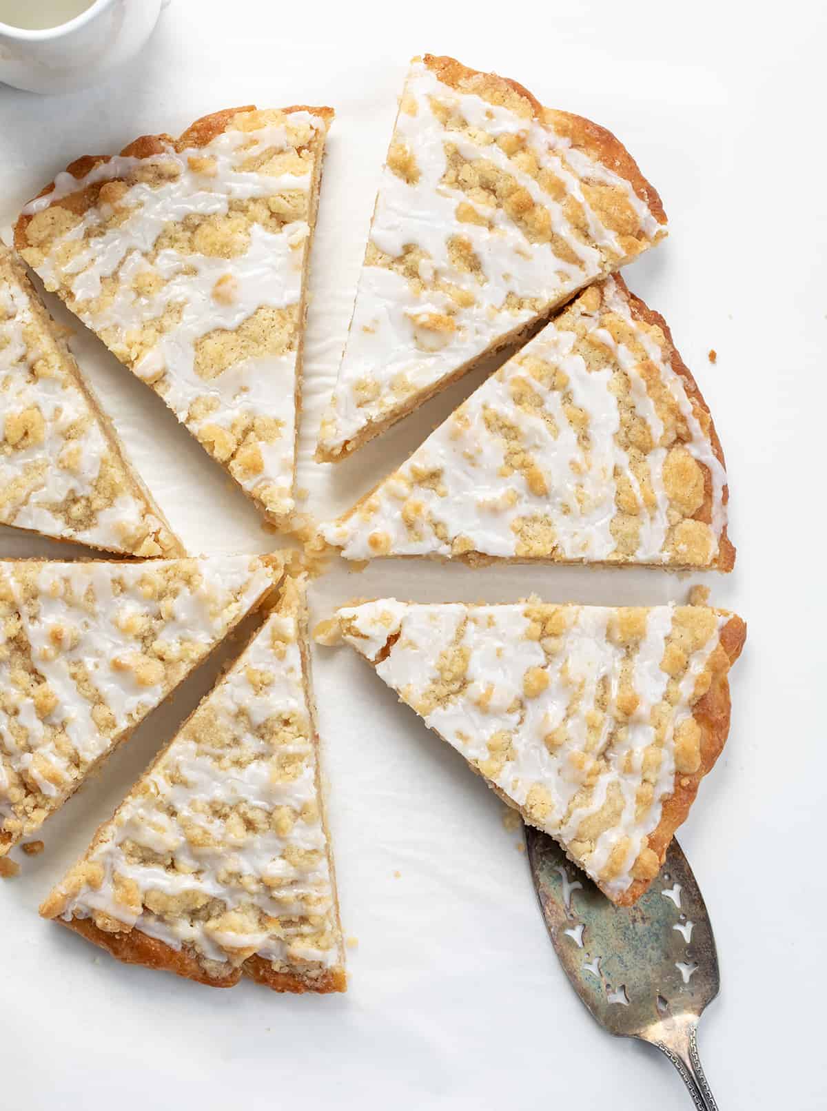 Dessert Pizza (Copycat Cactus Bread) Cut Into Pieces and Separated with One Being Removed with a Utensil.