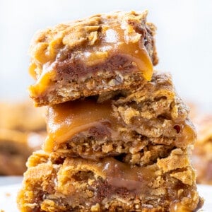 Chocolate Caramel Oatmeal Cookie Bars Stacked on Top of Each Other.