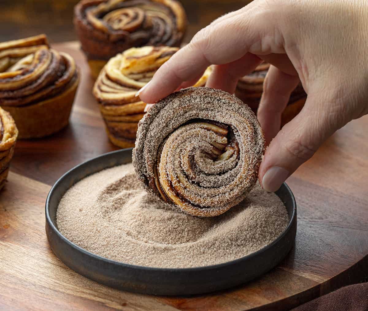 Rolling Chocolate Peppermint Cruffin into Cinnamon Sugar.