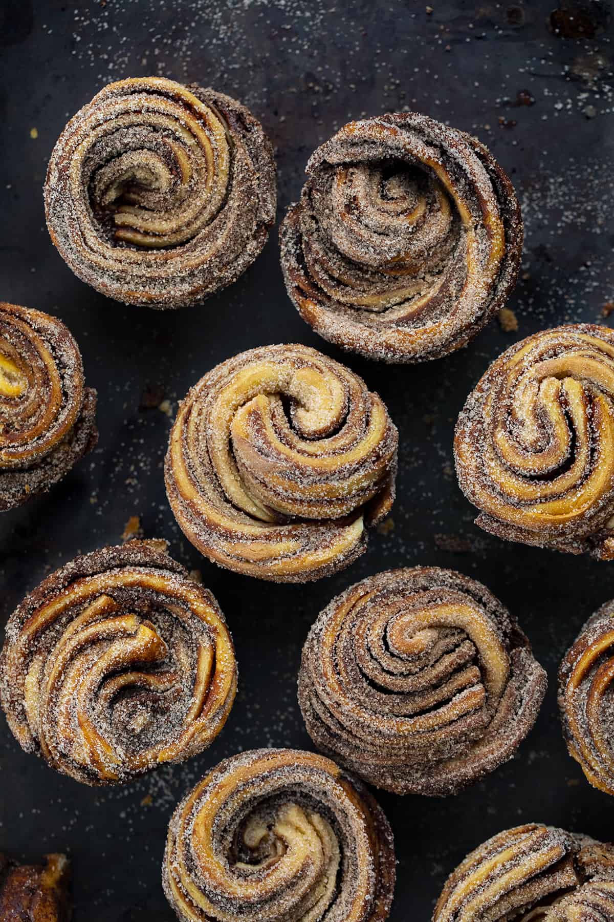 Many Chocolate Peppermint Cruffins on a Black Counter.