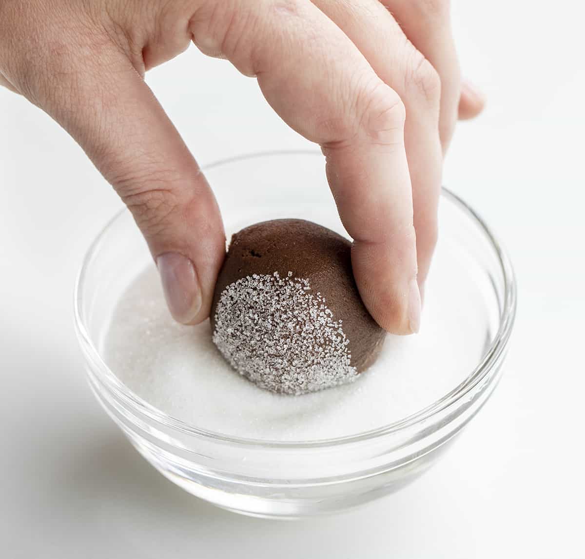 Dipping Chocolate Cookie Dough into Granulated Sugar.