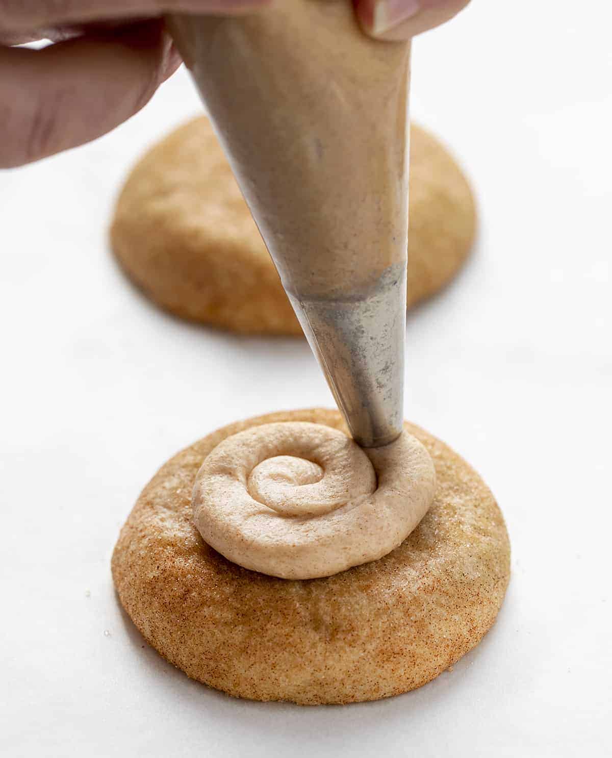 Piping Cinnamon Buttercream onto a Churro Cookie