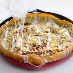 Drizzling Glaze over Cinnamon Sugar Dutch Baby. Breakfast, Dutch Baby, How to Make Dutch Baby, Easy Breakfast, breakfast recipes, breakfast for guests, i am baker, iambaker.