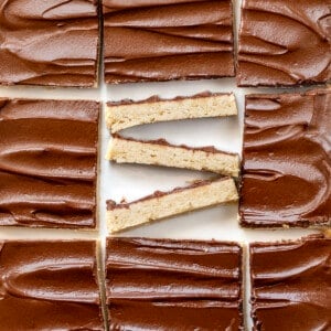 Cinnamon Shortbread Bars on a White Counter with the Center Bar Cut up and Put on its Side.