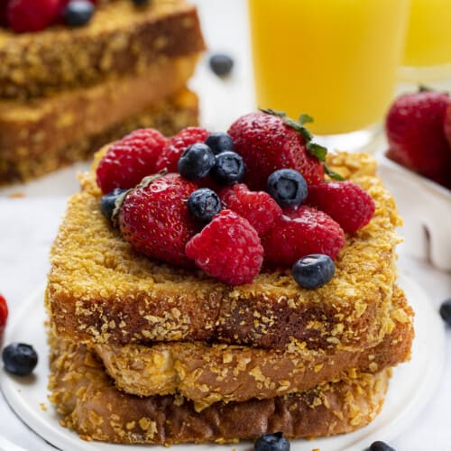 Stacks of Cornflake Crunchy French Toast with Orange Juice and Fruit