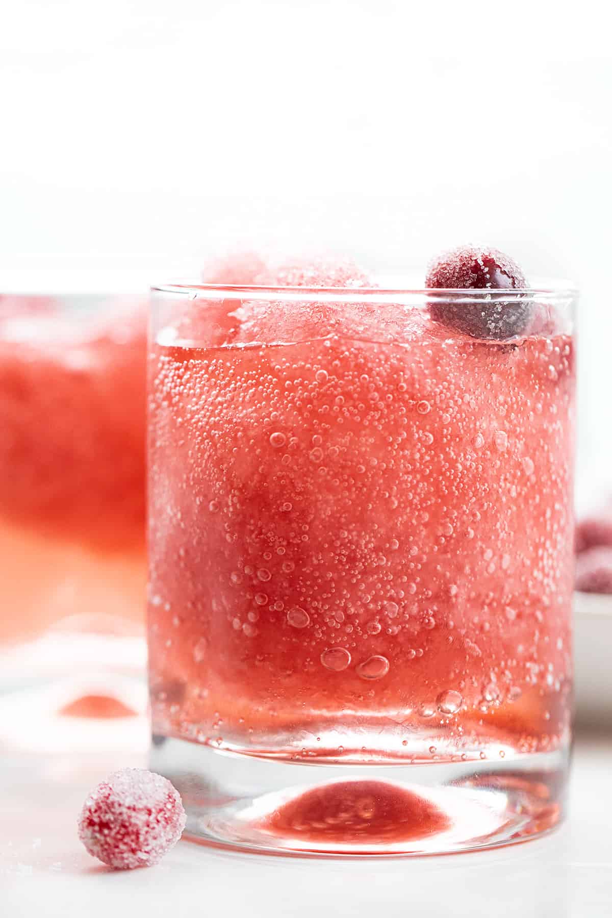 Glass of Cranberry Slush with Sugared Cranberries.