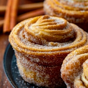 Close up of a Cruffin on a Black Platter. Baking, Breakfast, Cruffins, Croissant Muffins, Easy Cruffins, Easy Cruffin Recipe, Fall Baking, Cinnamon Cruffins, Cinnamon Sugar Cruffins, Dessert, Breakfast Ideas, Brunch Recipes, i am baker, iambaker