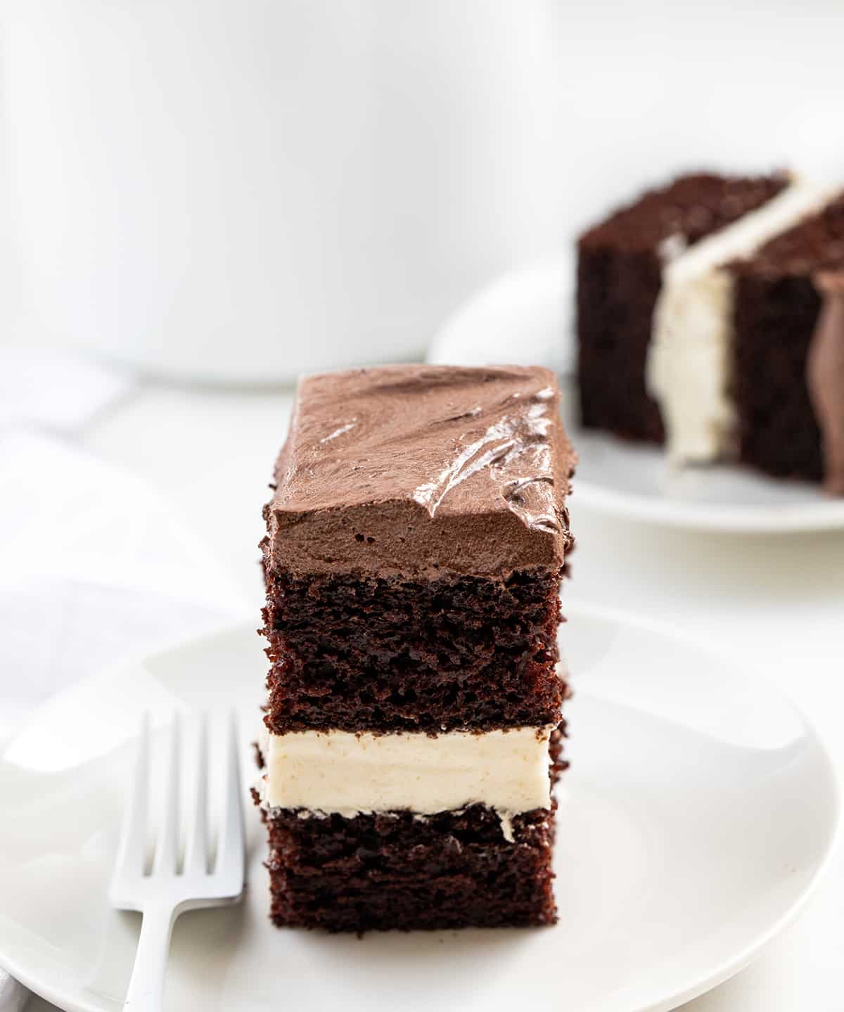 Pieces of Ding Dong Sheet Cake on White Plates.