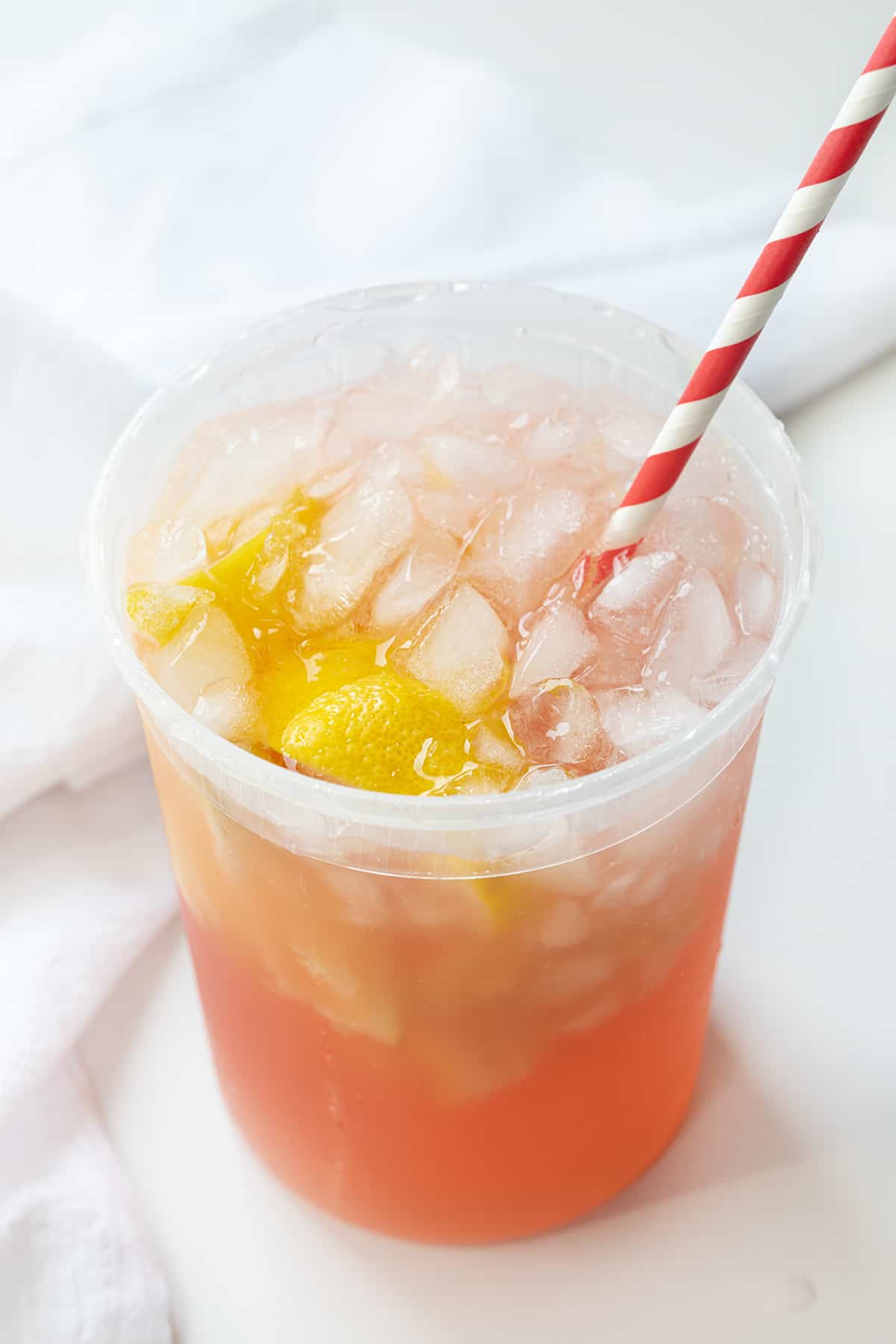 State Fair Strawberry Lemonade in a Container on a White Counter. 