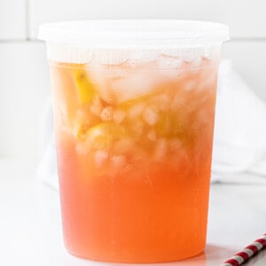 State Fair Strawberry Lemonade in a Container on a White Counter.