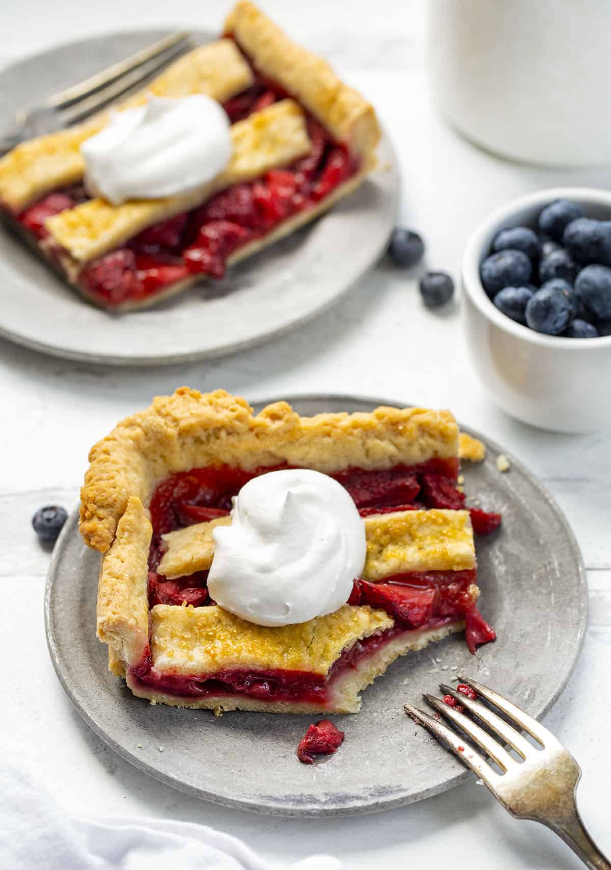 Two Pieces of Stars and Stripes Pie one Plates with One Bite Taken.