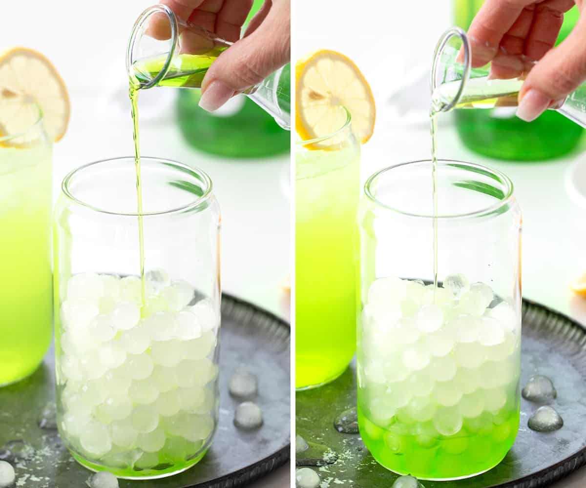 Adding Midori and Sour Apple Liqueur to a Glass with Lemonade Ice Cubes to Make Hulk Smash Cocktail.