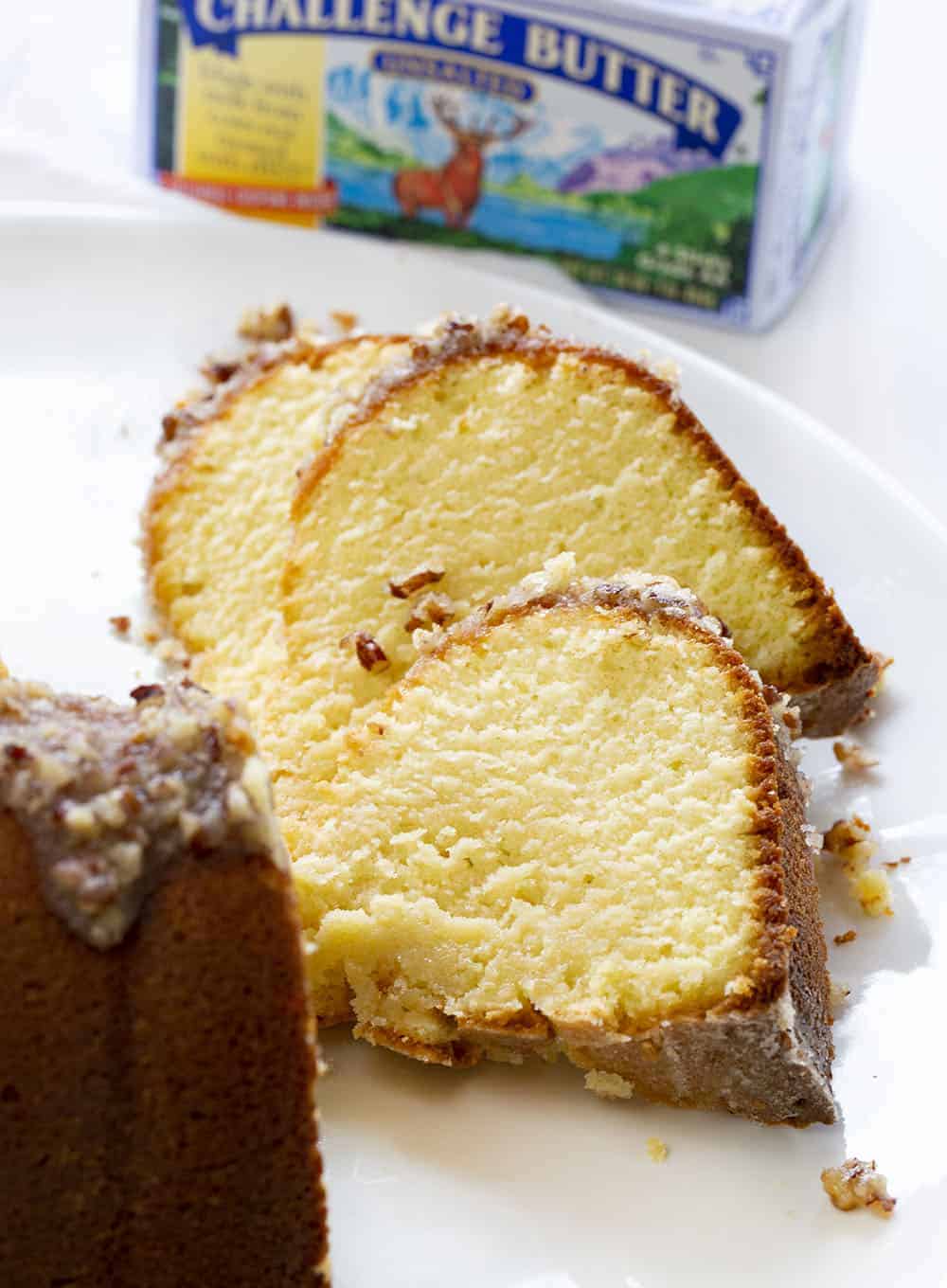 A perfect buttery pound cake with the most delicate crumb is topped with a pecan butter glaze. It's a SHOWSTOPPER!! pound cake, cake baking, kentucky butter crunch cake, kentucky butter cake, butter cake, iambaker, kentucky cake, butter crunch cake, dessert, best desserts, best cake Slices of Kentucky Butter Crunch Cake