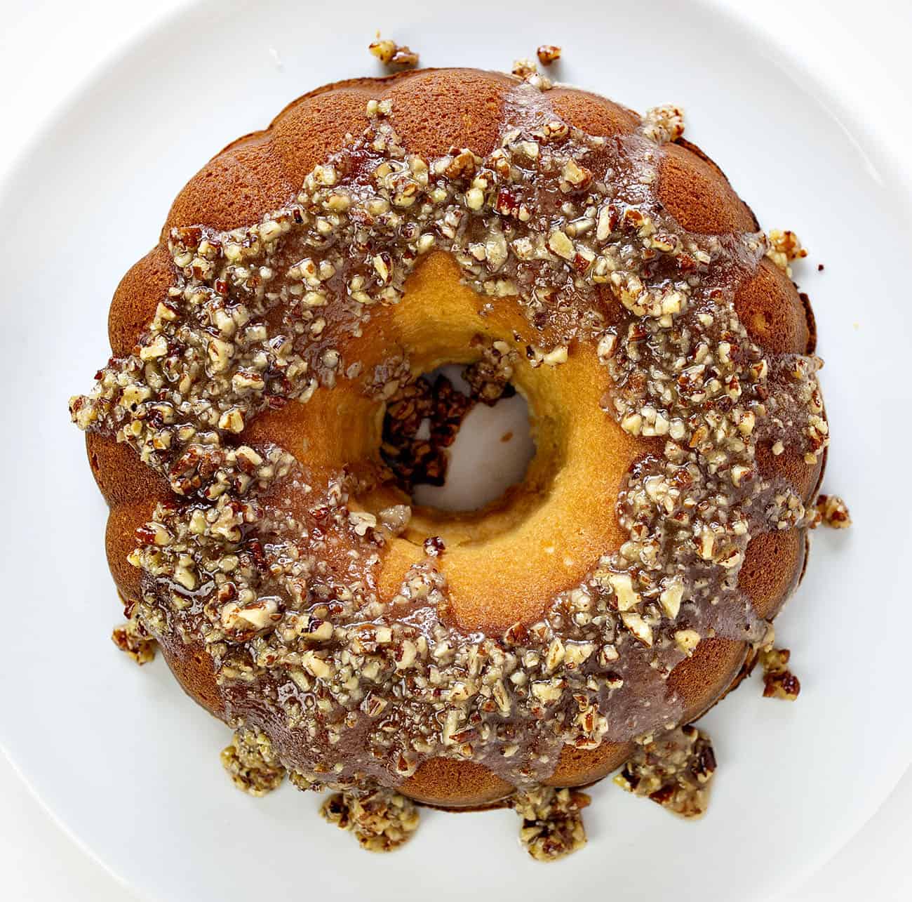 A perfect buttery pound cake with the most delicate crumb is topped with a pecan butter glaze. It's a SHOWSTOPPER!! pound cake, cake baking, kentucky butter crunch cake, kentucky butter cake, butter cake, iambaker, kentucky cake, butter crunch cake, dessert, best desserts, best cake Overhead view of Kentucky Butter Crunch Cake