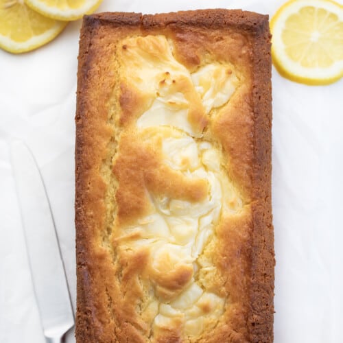 Overhead of a Lemon Cream Cheese Loaf on Counter with Lemons.