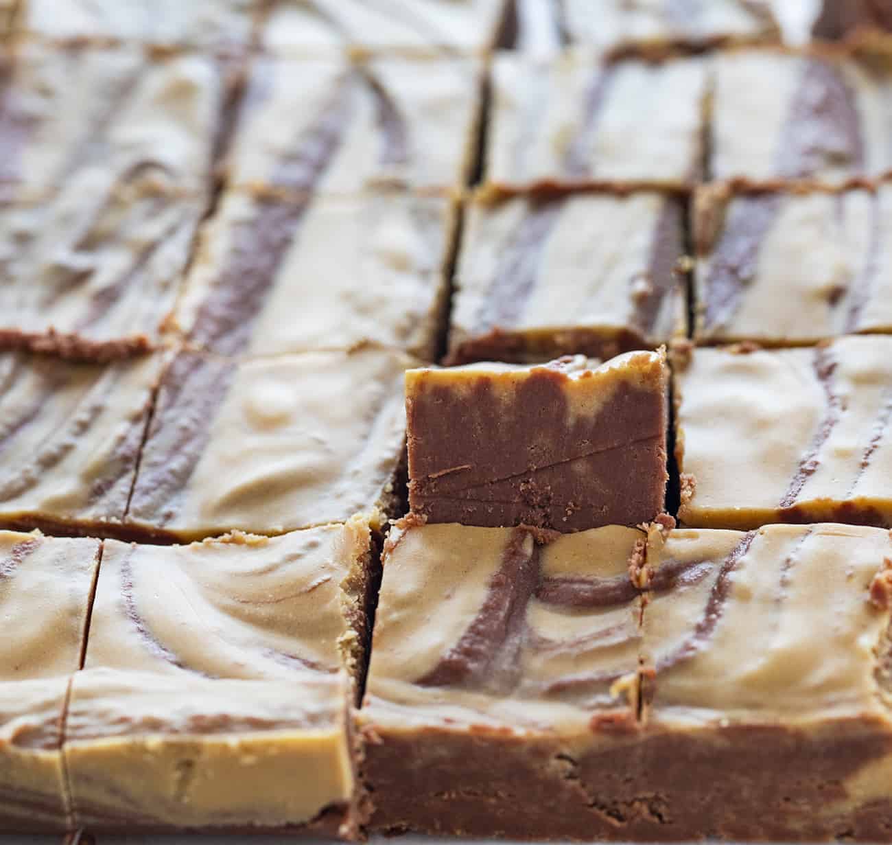 One piece of Chocolate Peanut Butter Fudge upright In a cut pan