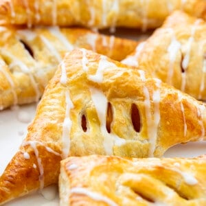 Peach Turnovers on a White Counter with Peaches.