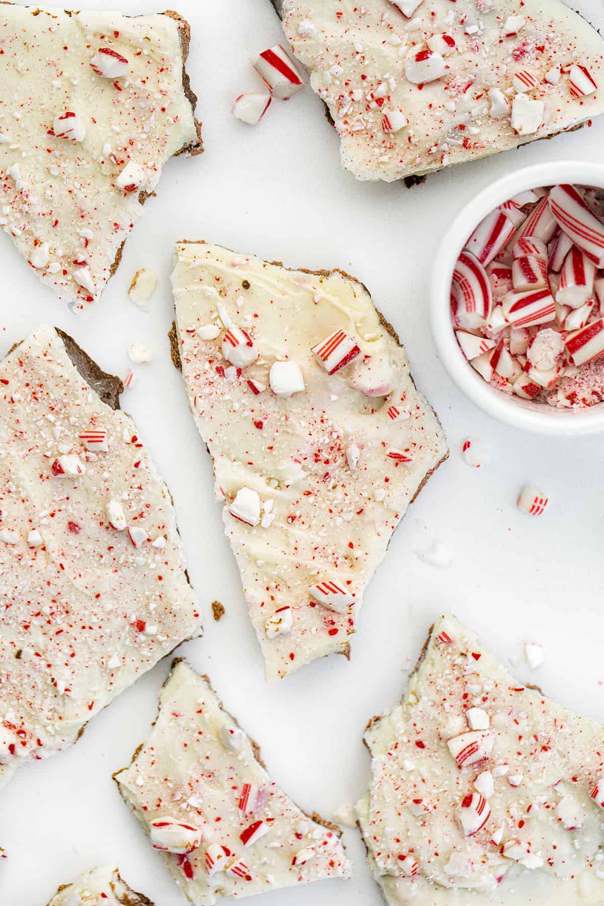 Peppermint Bark is a no-bake candy treat with a milk chocolate peppermint layer topped with a white chocolate peppermint candy cane mixture with more crushed candy canes on top. Holidays, Chocolate Bark, How to Make Bark, Easy Peppermint Bark. Williams Sonoma Peppermint Bark, Christmas Dessert, No Bake Dessert, New Years Ever Dessert, chocolate, chocolate recipes, i am baker, iambaker Overhead of Peppermint Bark with Broken Candy Canes