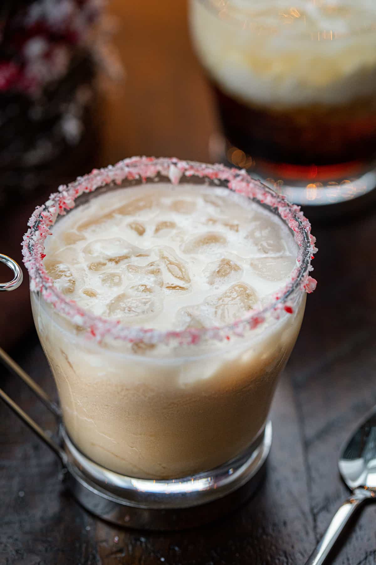 Peppermint White Russians in front of a Christmas Tree and Twinkling Lights.