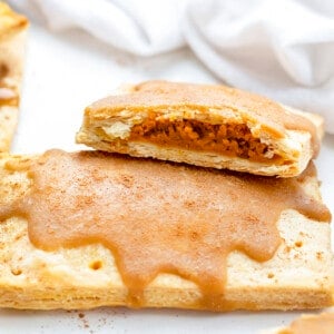 One Whole and One Halved Pumpkin Pie Pop Tart on White Counter. Breakfast, Pumpkin Dessert, Pumpkin Recipes, Baking, How to Make Pop Tarts, Breakfast Recipe Ideas, Dessert, Snacks, Treats, Fall Treats, Fall Baking Recipes, i am baker, iambaker