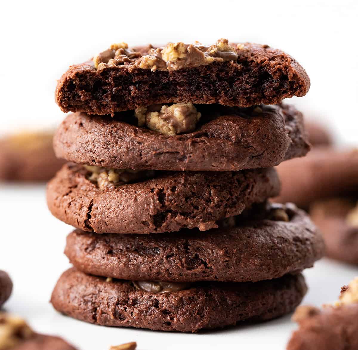 Stack of Reese's Cake Mix Cookies with Top Cookie Broken Showing the Inside.