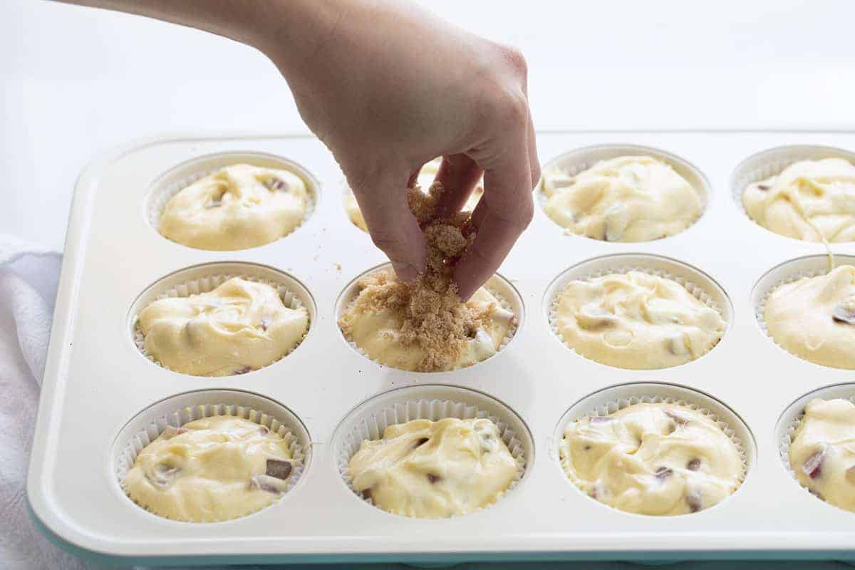 Adding Streusel to Rhubarb Muffins.