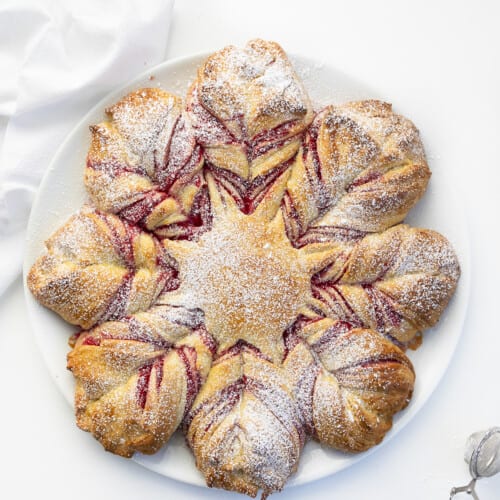 CranberryOrange Star Bread on a White Platter on a White Counter. Dessert, Baking, Holiday Baking, Star Bread, Christmas Dessert, Christmas Bread, Thanksgiving Bread, Thanksgiving Bread, New Years Eve Dessert, Holiday Recipes, Entertaining Recipes, i am baker, iambaker