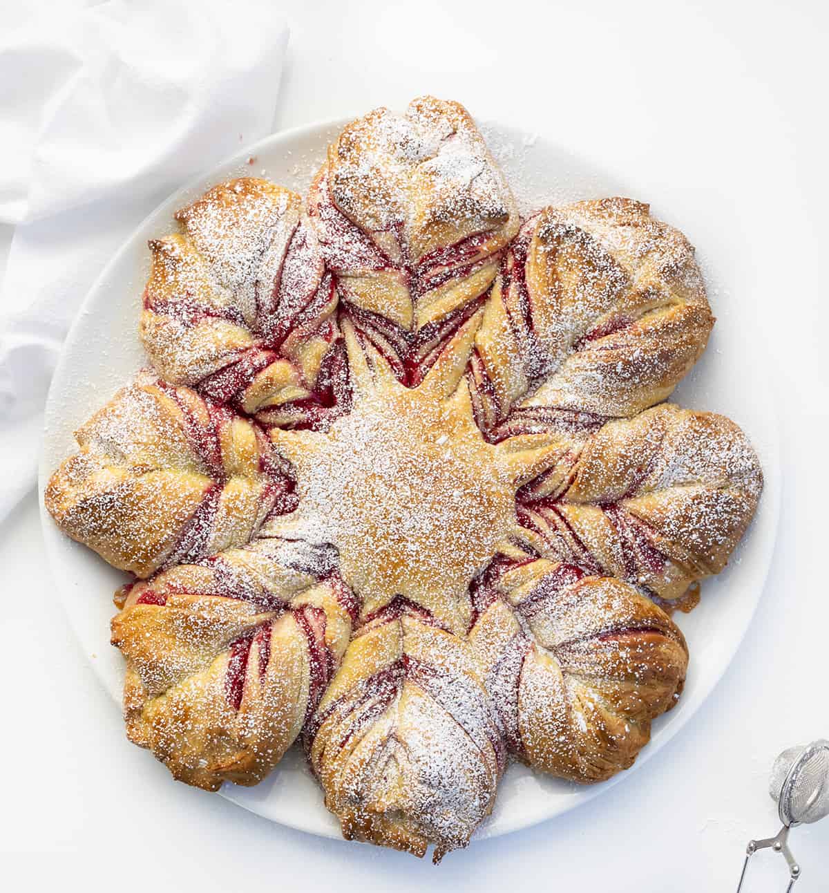 CranberryOrange Star Bread on a White Platter on a White Counter. Dessert, Baking, Holiday Baking, Star Bread, Christmas Dessert, Christmas Bread, Thanksgiving Bread, Thanksgiving Bread, New Years Eve Dessert, Holiday Recipes, Entertaining Recipes, i am baker, iambaker