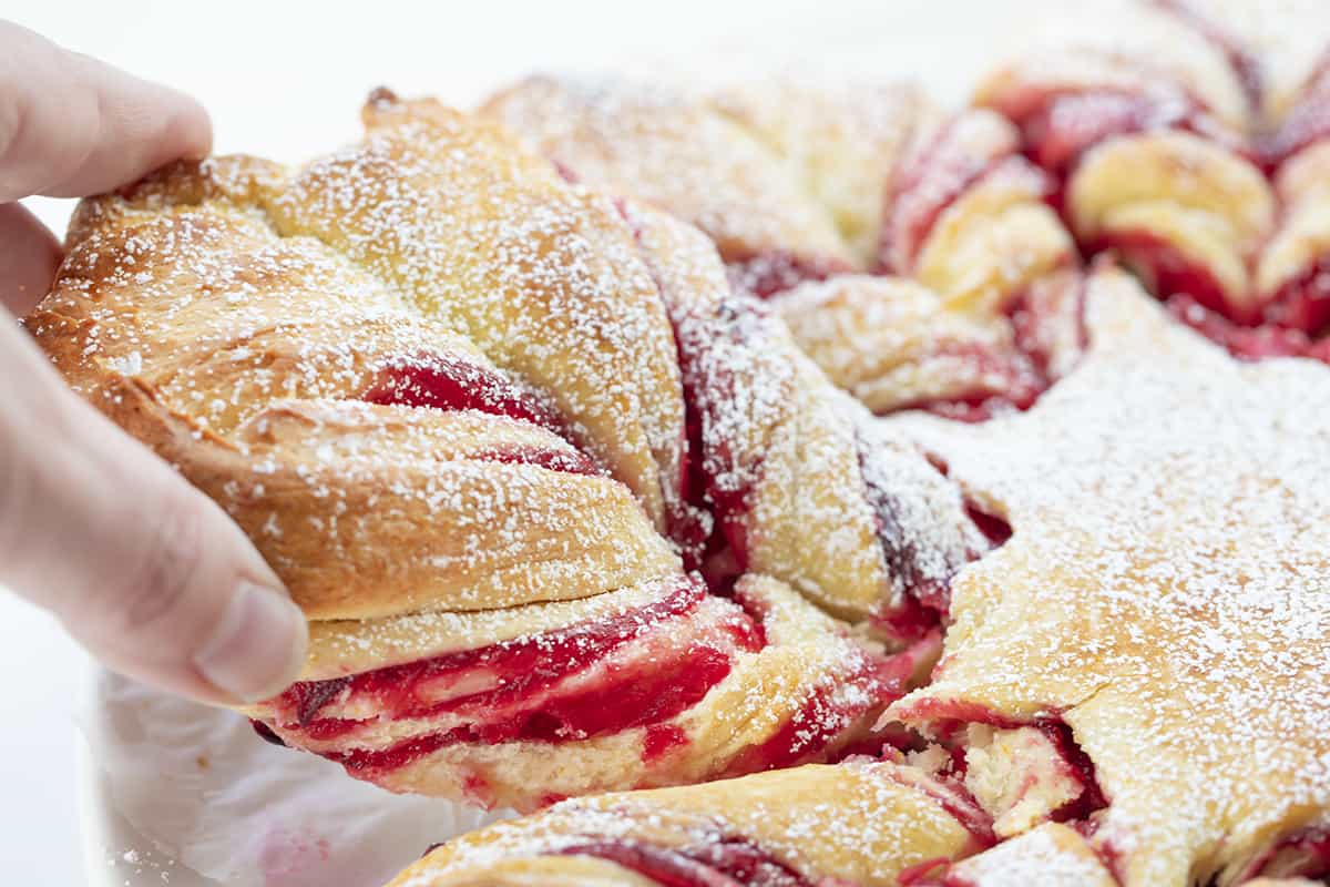 Hand Picking up a Piece of Cranberry Orange Star Bread. Dessert, Baking, Holiday Baking, Star Bread, Christmas Dessert, Christmas Bread, Thanksgiving Bread, Thanksgiving Bread, New Years Eve Dessert, Holiday Recipes, Entertaining Recipes, i am baker, iambaker