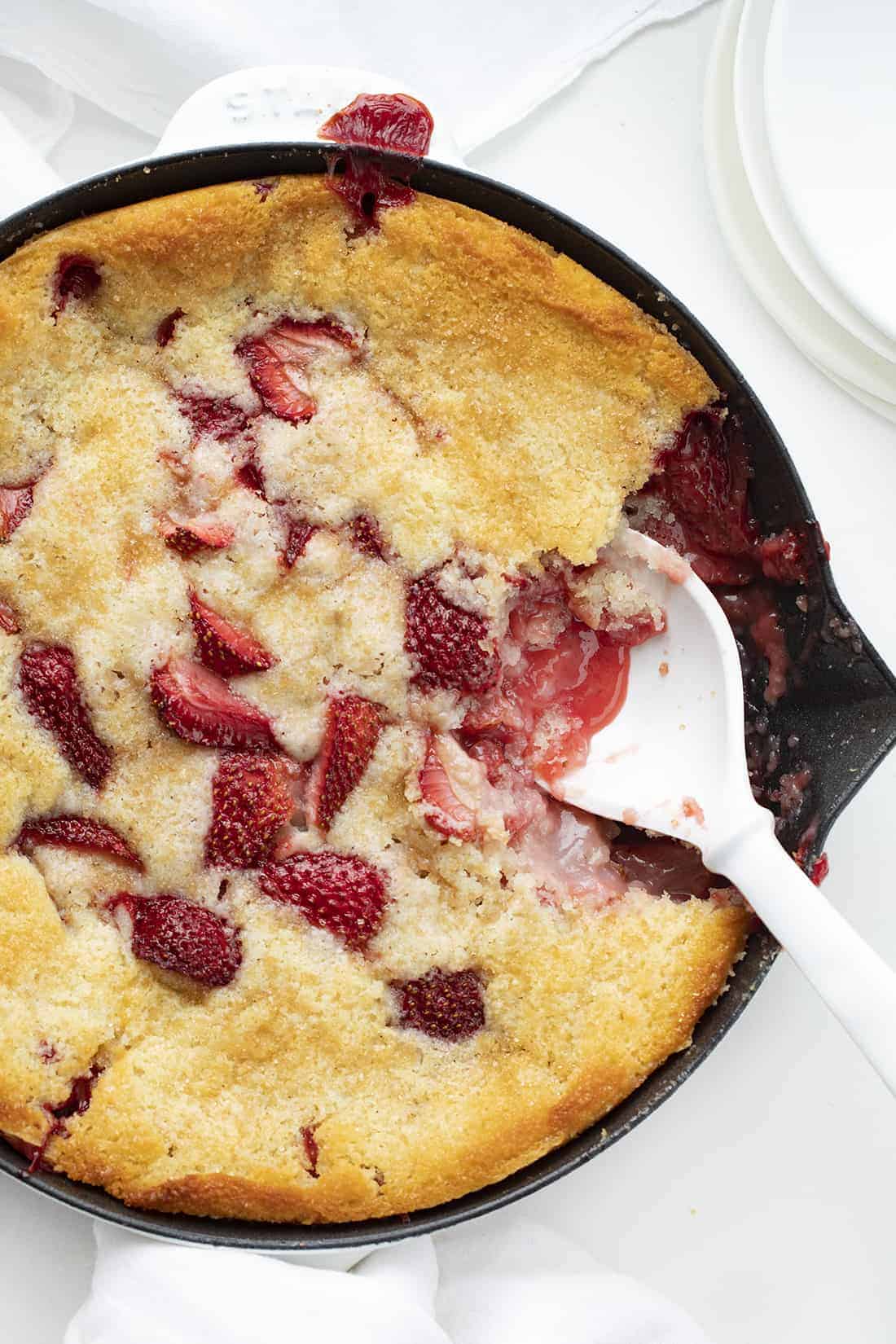 Fresh Strawberry Cobbler is a perfect summertime dessert that can be put together in minutes and features fresh strawberries. Strawberry Cobbler, Fresh Strawberry Cobbler, How to Make Strawberry Cobbler, Cobble Recipes, Easy Cobbler, From-Scratch Cobbler, Baking, Dessert, Summer Dessert, Easy Dessert, iambaker, i am baker Skillet with Strawberry Cobbler