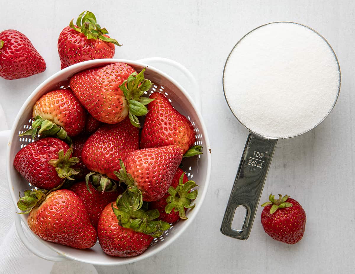 Strawberry Simple Syrup is a homemade sweetener made with just three ingredients, sugar, water, and fresh strawberries. It can add a sweet and fruity flavor to a variety of recipes from beverages to desserts to salads. If you can boil water, you can make simple syrup! Raw Strawberries and Sugar Before Making Strawberry Simple Syrup.