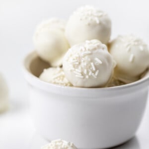 Sugar Cookie Truffles in a White Bowl on a White Counter.