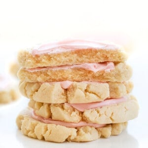 Stack of Copycat Swig Frosted Sugar Cookies with Top Cookies Broken in Half Showing Inside. Dessert, Cookies, Cookie Recipes, Swig Copycat, Baking, Cookie Exchange, Frosted Cookies, iambaker cookie recipes, the best sugar cookies, sugar cookie, i am baker, iambaker