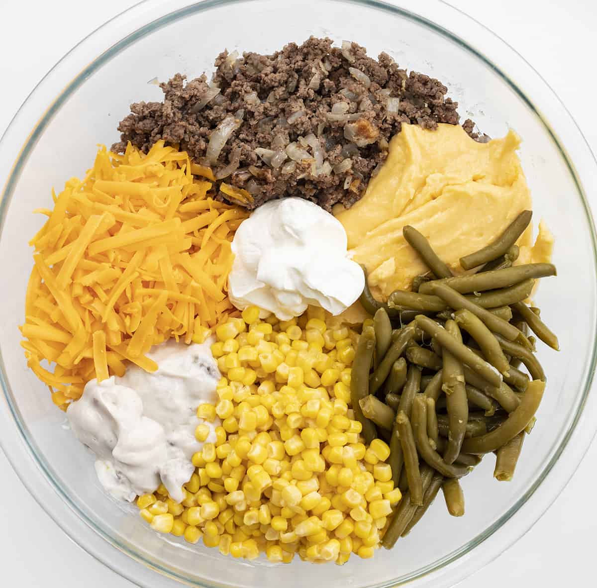 Raw Ingredients for tater tot hotdish in a glass bowl