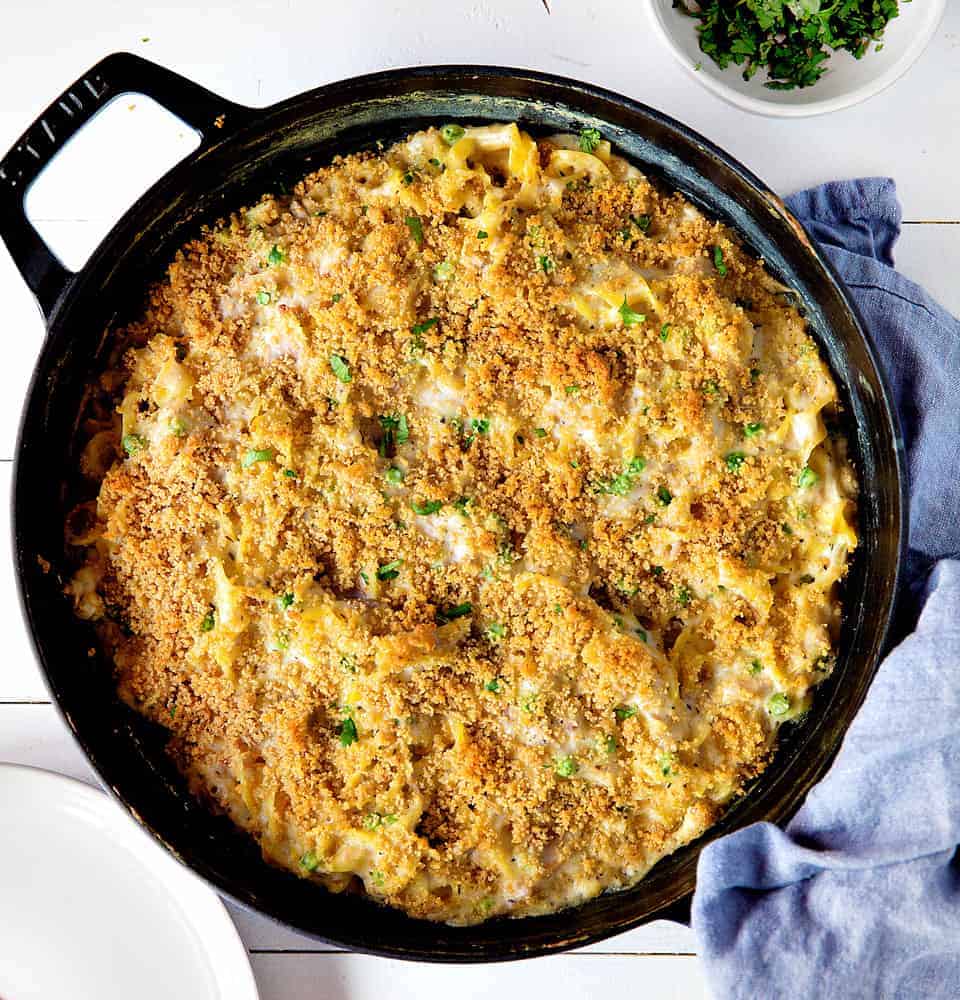 A perfect tuna casserole recipe with all the traditional fixins... this casserole is timeless! tuna casserole, tuna casserole recipe, tuna noodle casserole, iambaker, i am baker, dinner, recipes, casserole recipes, tuna recipes Tuna Casserole Shot Overhead in a Skillet with Blue Towel