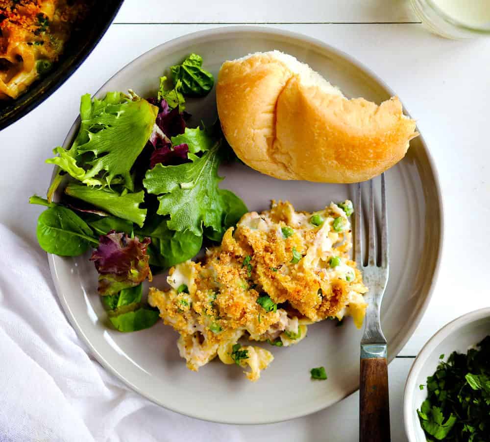 A perfect tuna casserole recipe with all the traditional fixins... this casserole is timeless! tuna casserole, tuna casserole recipe, tuna noodle casserole, iambaker, i am baker, dinner, recipes, casserole recipes, tuna recipes Tuna Casserole on a Plate with Salad and Bread