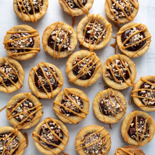 Several Turtle Cookie Cups on a White Counter from Overhead.