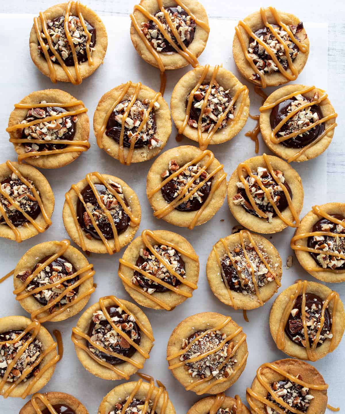 Several Turtle Cookie Cups on a White Counter from Overhead.