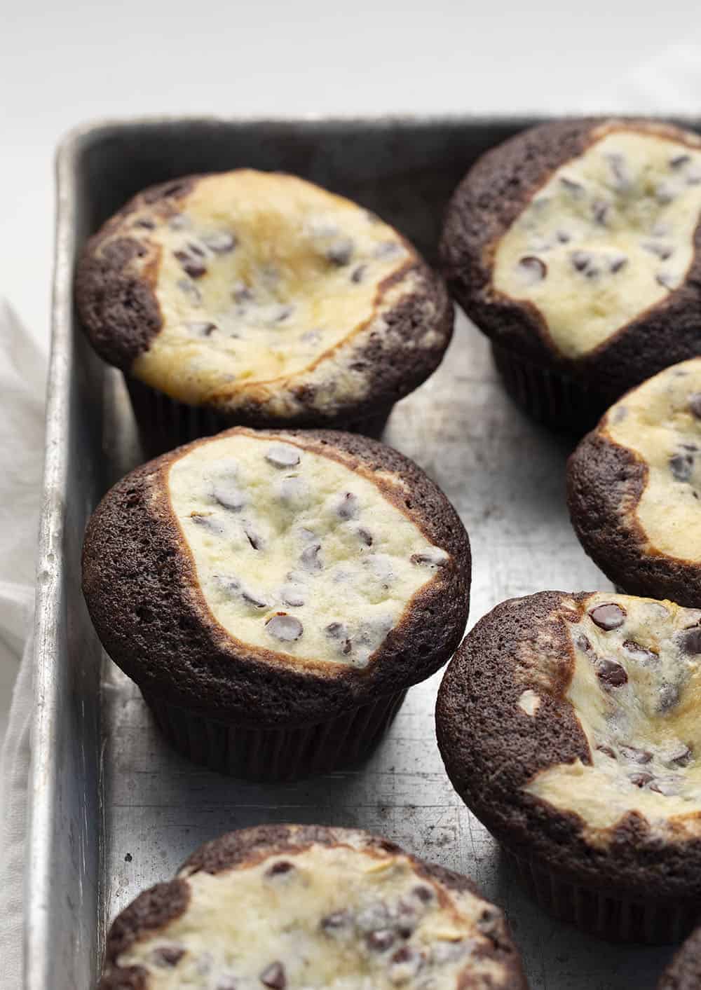 Tuxedo Cupcakes are rich, chocolate cupcakes topped and baked with a dollop of a cream cheese and chocolate chip mixture for a dessert that is as fancy as it is delicious! Tuxedo Cupcakes, Black Bottom Cupcakes, Chocolate Cupcakes, Chocolate Cream Cheese Cupcakes, Cupcakes, Recipes, Baking, Desserts, i am baker, iambaker, cupcake recipes Tuxedo Cupcakes in Pan