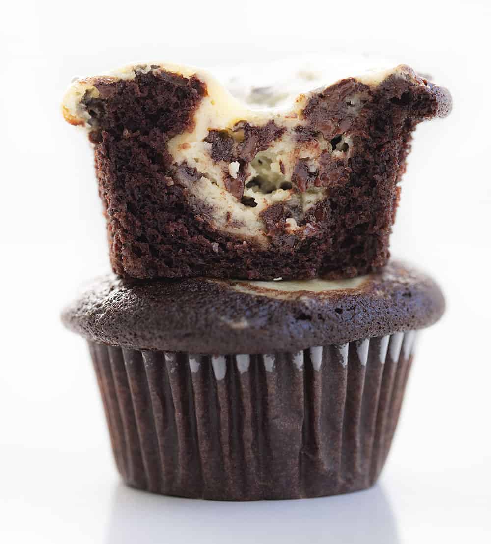 Tuxedo Cupcakes are rich, chocolate cupcakes topped and baked with a dollop of a cream cheese and chocolate chip mixture for a dessert that is as fancy as it is delicious! Tuxedo Cupcakes, Black Bottom Cupcakes, Chocolate Cupcakes, Chocolate Cream Cheese Cupcakes, Cupcakes, Recipes, Baking, Desserts, i am baker, iambaker, cupcake recipes Tuxedo Cupcakes Stacked and Showing Inside