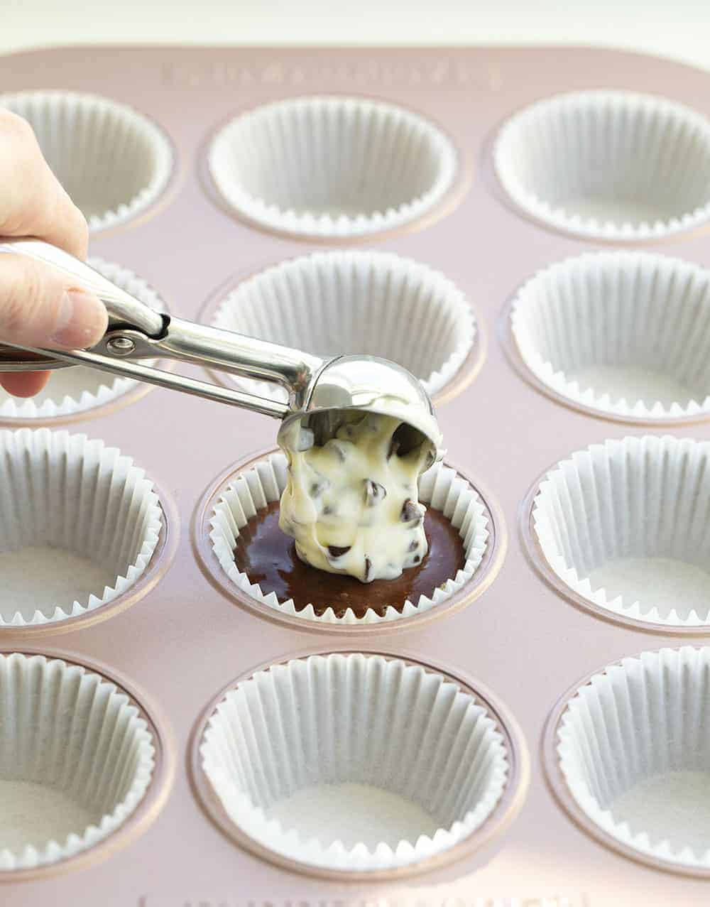 Tuxedo Cupcakes are rich, chocolate cupcakes topped and baked with a dollop of a cream cheese and chocolate chip mixture for a dessert that is as fancy as it is delicious! Tuxedo Cupcakes, Black Bottom Cupcakes, Chocolate Cupcakes, Chocolate Cream Cheese Cupcakes, Cupcakes, Recipes, Baking, Desserts, i am baker, iambaker, cupcake recipes Adding Cream Cheese to Tuxedo Cupcakes