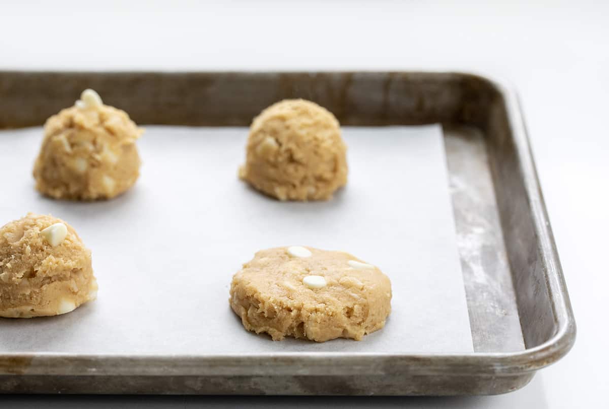 One White Chocolate Macadamia Nut Cookie Pressed Down Before Baking.