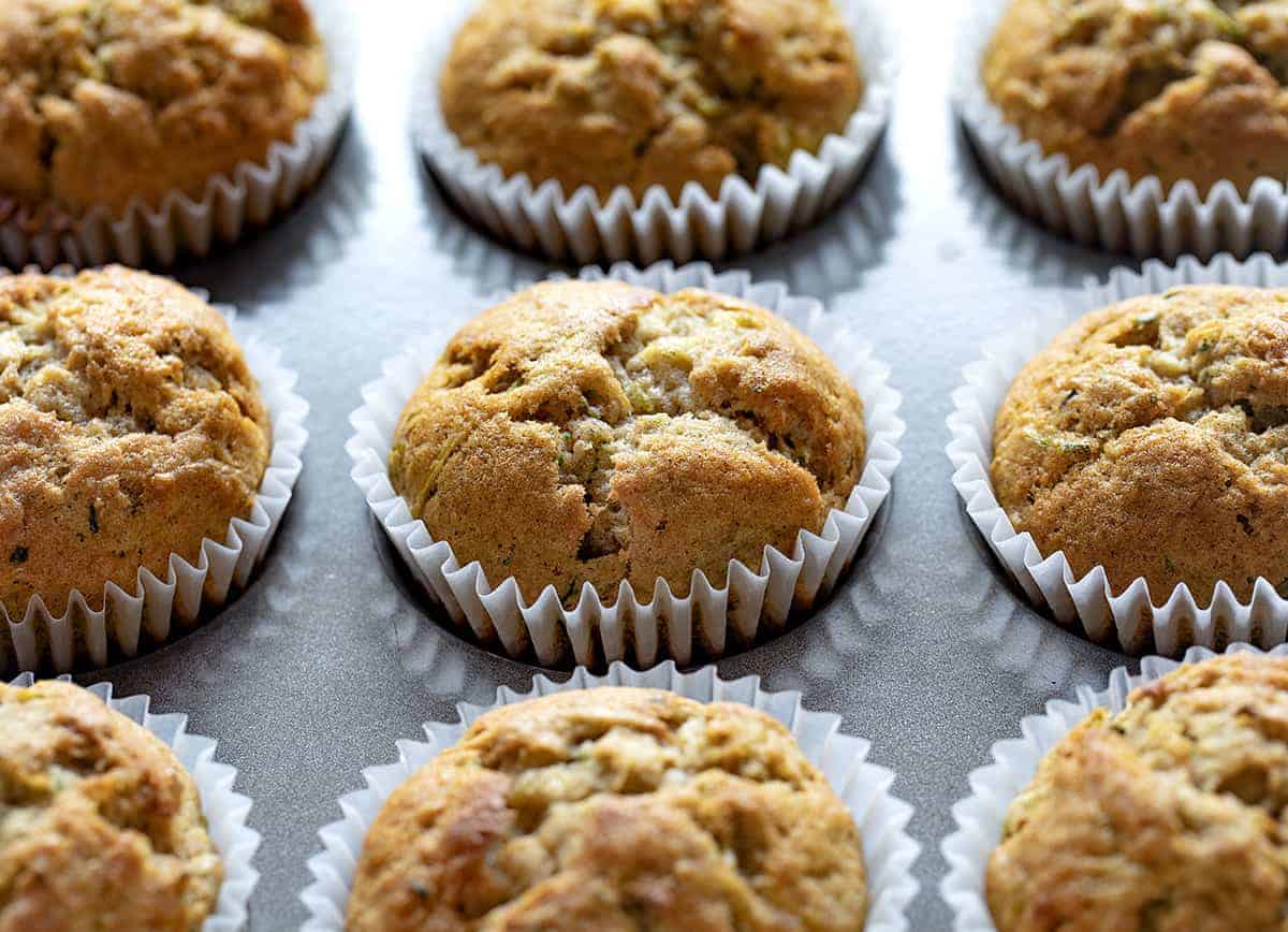 Banana Zucchini Muffins are so moist and delicious, you will never think of buying a muffin again! banana zucchini muffins, zucchini muffins, banana muffins, homemade muffins, iambaker, baking, muffins, bananas, zucchini recipes Banana Zucchini Muffins in a Pan Close Up.